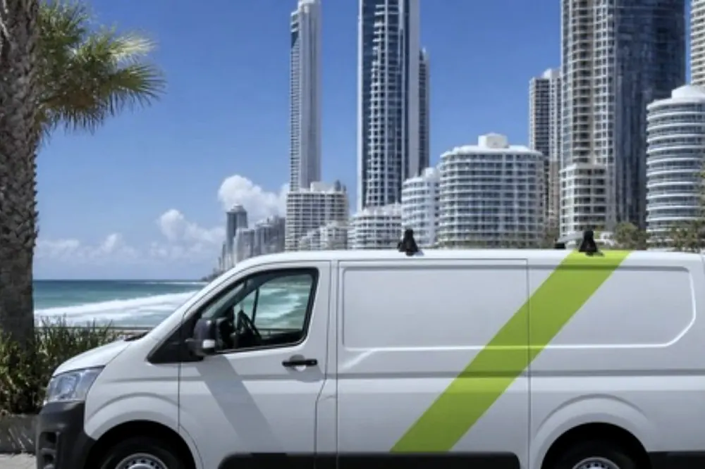 White Laser Printers service van parked on a Gold Coast street near high rise buildings