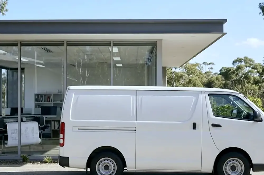 White service van parked outside a modern Gold Coast office building