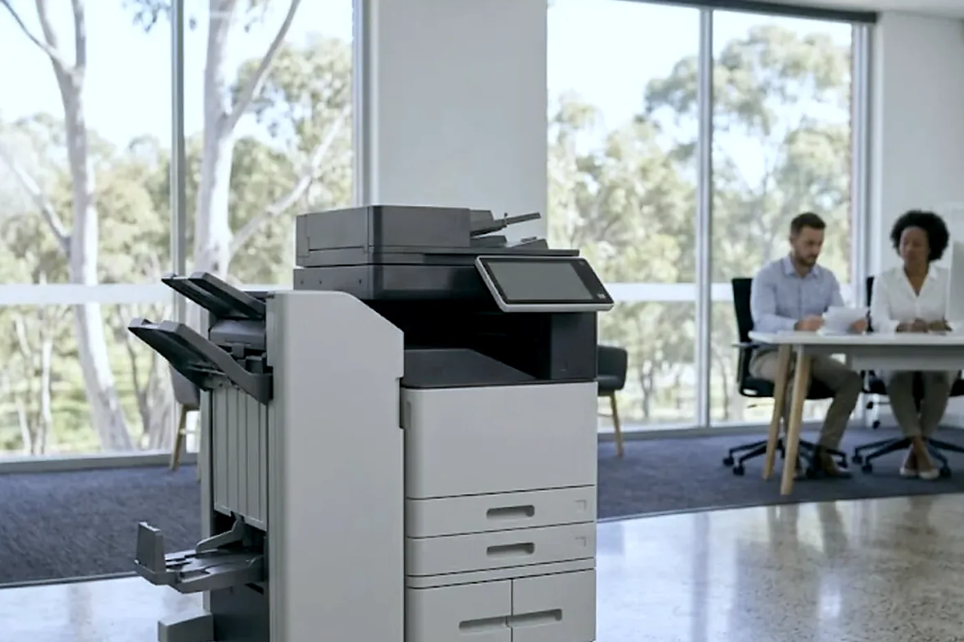 Floor standing copier with finisher in a bright open plan Gold Coast office